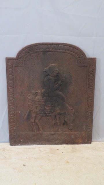 18th century European wrought iron fire back: 18th century European wrought iron fire back with woman on burro carrying baskets of wine jugs, 29"T x 23"W x 1/2"thick