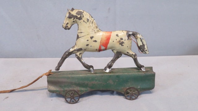 Early American tin trotting horse toy on wheels: Early American tin trotting horse toy on wheels, some old solder repairs, 5.5"T x 6.5"L x 2.5"W