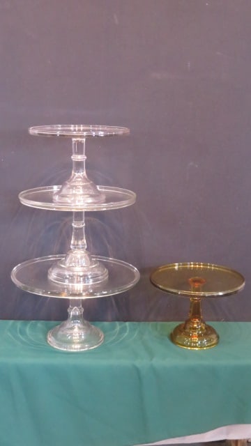 4 early APG cake stands: 4 early APG cake stands, one is amber, the other 3 clear are graduated, largest is 15"diam x 8"T, with smaller ones being 13" and 11", amber is 11"diam