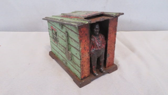 Darkie in a Cabin Mechanical Bank: Cast iron Darkie in a Cabin mechanical bank, Patent June 30, 1885, attributed to J.E. Stevens, 3 3/4"t. x 4 1/4" x 2 3/4"