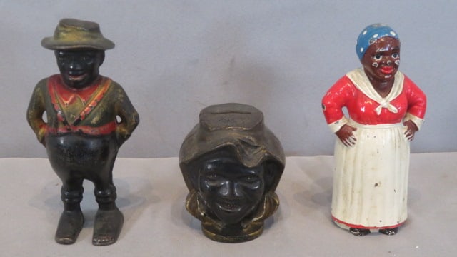 3 Black memorabilia cast iron still banks: 3 Black memorabilia cast iron still banks, including a sharecropper with suspenders 5.5"T, a 2-faced sharecropper head, and a mammy