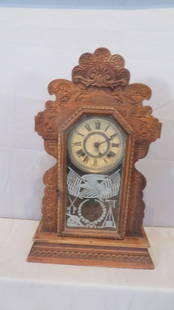 Shelf clock with Patriotic tablet: Ansonia oak kitchen shelf clock with original patriotic glass tablet with flags, spread wing eagle, cannon and bugle, 22" t. x 14" at base, 8 day spring driven movement