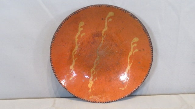 Early 19th century 9.75" redware plate with slip decoration: Early 19th century 9.75" redware plate with slip decoration, scroggeled edge