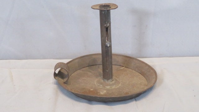 19th century tin saucer base candleholder: 19th century tin saucer base candleholder, has a push-up, 7"T x 9"diam