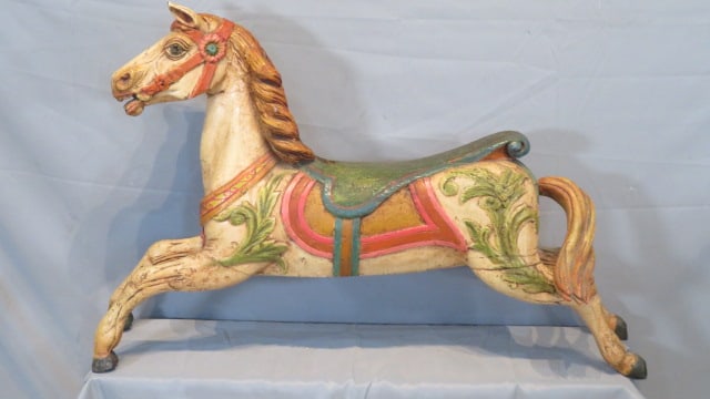 20th century diminutive wood carousel horse: 20th century diminutive wood carousel horse with glass eyes, old working paint, carved saddle and tail, 28"t. x 43"l. x 13 1/2"