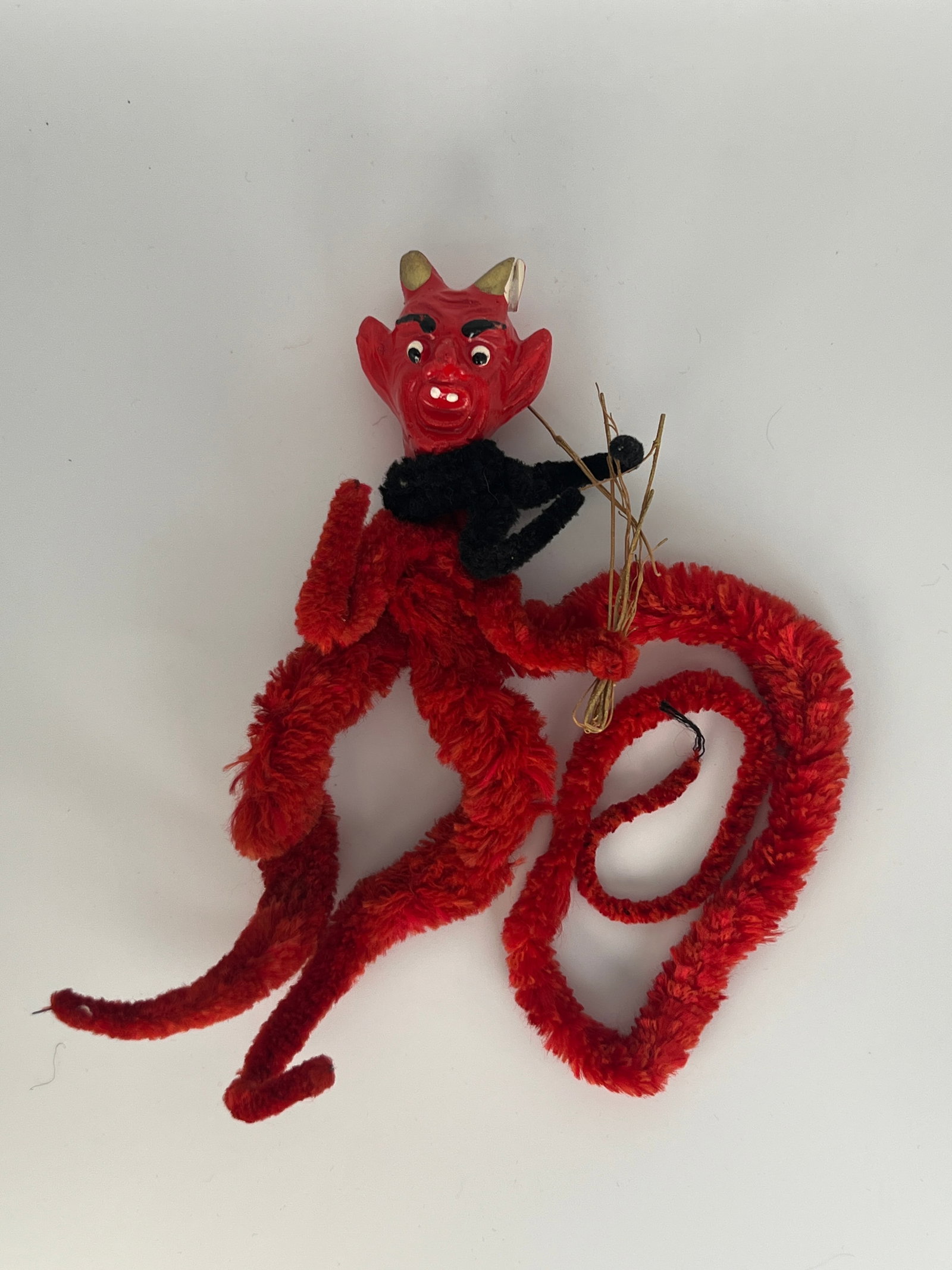 German Krumpas Figurine Chenille Body: Vintage Krumpas figurine Christmas decoration chenille body & long tail, hand painted composite head. Repair on left ear. 4"W x 8" T with 16" Tail.