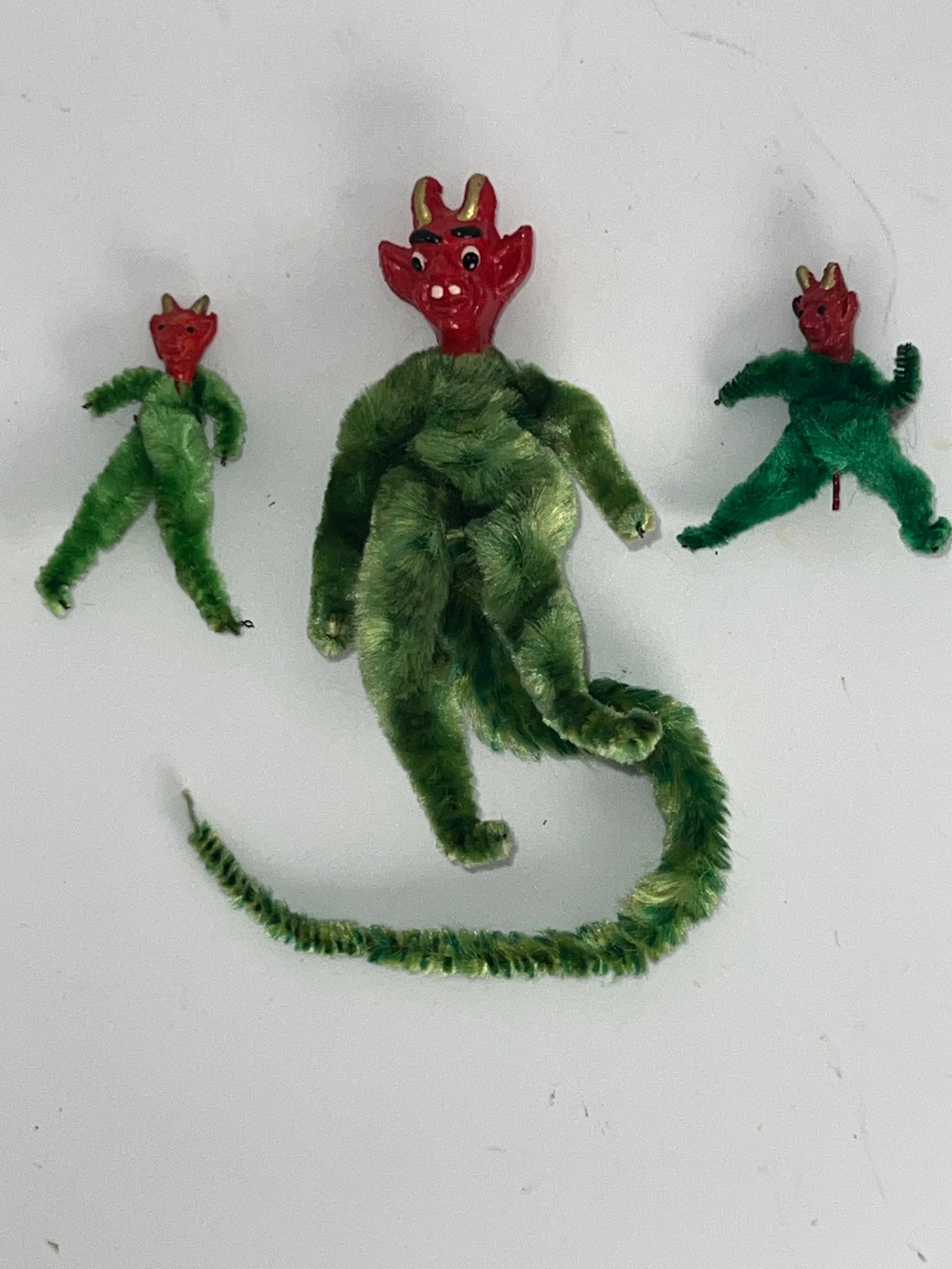Group of Three Krumpas Ornaments: Group of 3 Krumpas Chenille body ornaments. 1 w/ long tail. All 3 green. Largest is 4"T w/ 8"tail