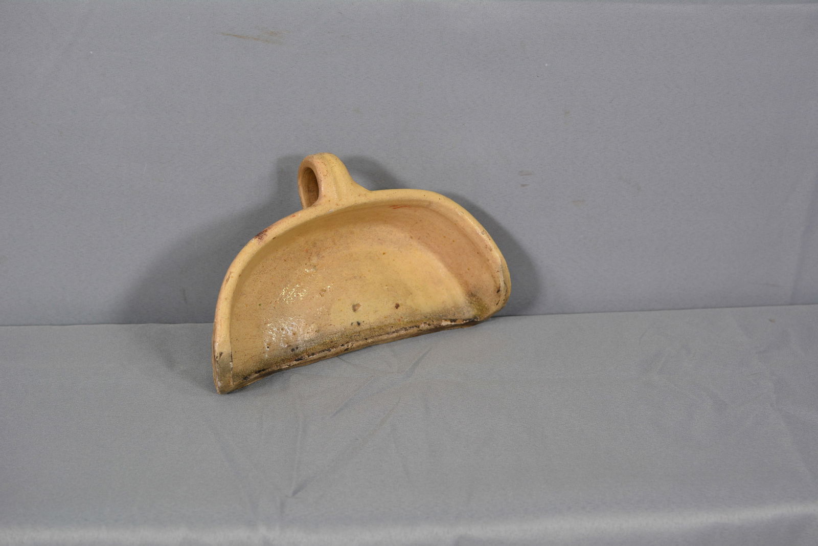 Stoneware Finger Loop Scoop: Unusual finger loop yellow ware stoneware scoop w/ glazed front edge. 10"W x 6"D x 3"T. From the Collection of Roselyn Potts.