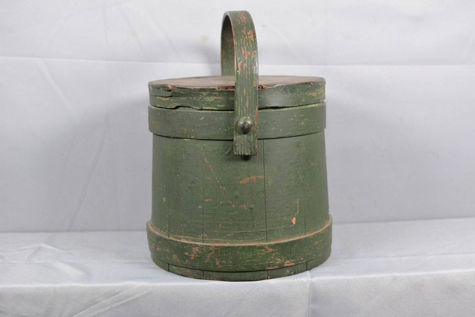 Firkin in Old Green Paint: Old green paint finger lap firkin w/ swing handle. Nice wear. Lid has splinting. 10"W x 10"T