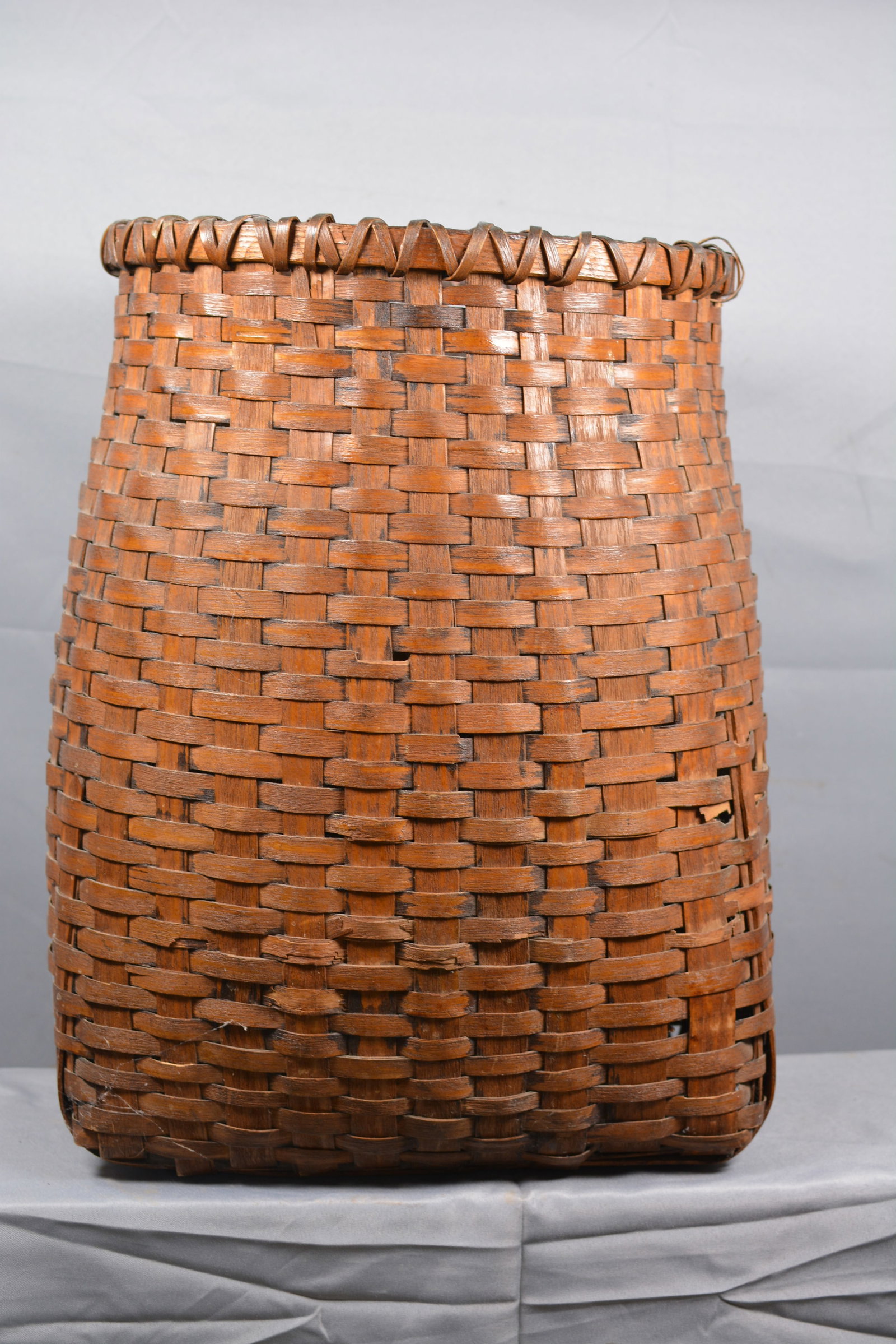 Tall Hand Weave Down Feather Basket: Nice dark finish hand weaved tall down feather basket. From the collection of Doug & Sandy Davies.