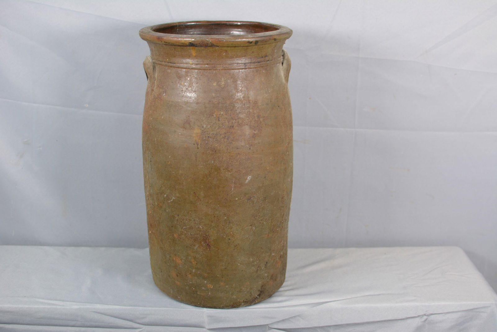 Six Gallon Stoneware Churn: Six gal. stoneware churn, no lid, double handles. 11"W x 19"T Small chip in rim. From the Collection of Roselyn Potts.