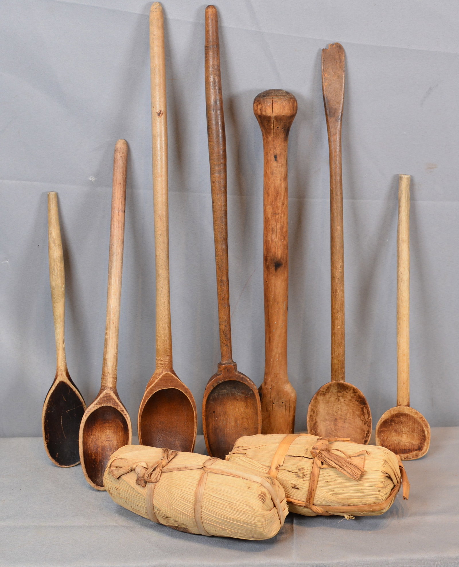 Group of Early Wooden Spoons & Two Lycha Panela: 7 early wooden spoons & 2 packed brown sugar " Lycha Panela" wrapped in corn husks. Longest 19"L