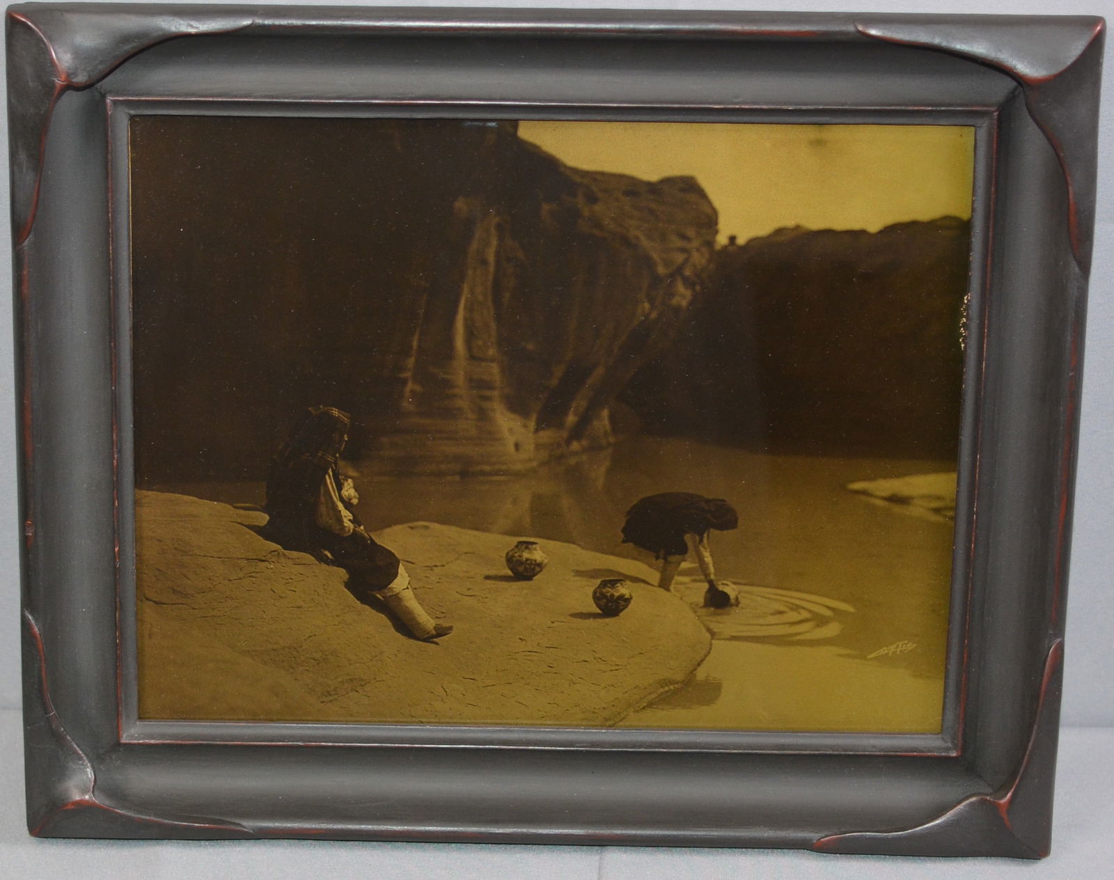 Outstanding Orotone Photograph, "At the Old Well of Acoma" by Edward Sheriff Curtis (American: Outstanding Orotone Photograph, "At the Old Well of Acoma" by Edward Sheriff Curtis (American Photographer, 1868-1952), ca 1904 Orotone photograph. Acoma girls gather water at the well. Signed in the