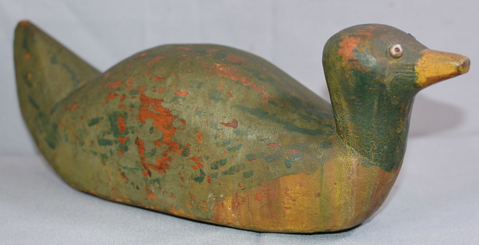 Folk Art Decoy in old green paint, old yellow paint beak, tac eyes, underside has 3 - 1" drilled: Folk Art Decoy in old green paint, old yellow paint beak, tac eyes, underside has 3 - 1" drilled holes. 14"x6"x7"