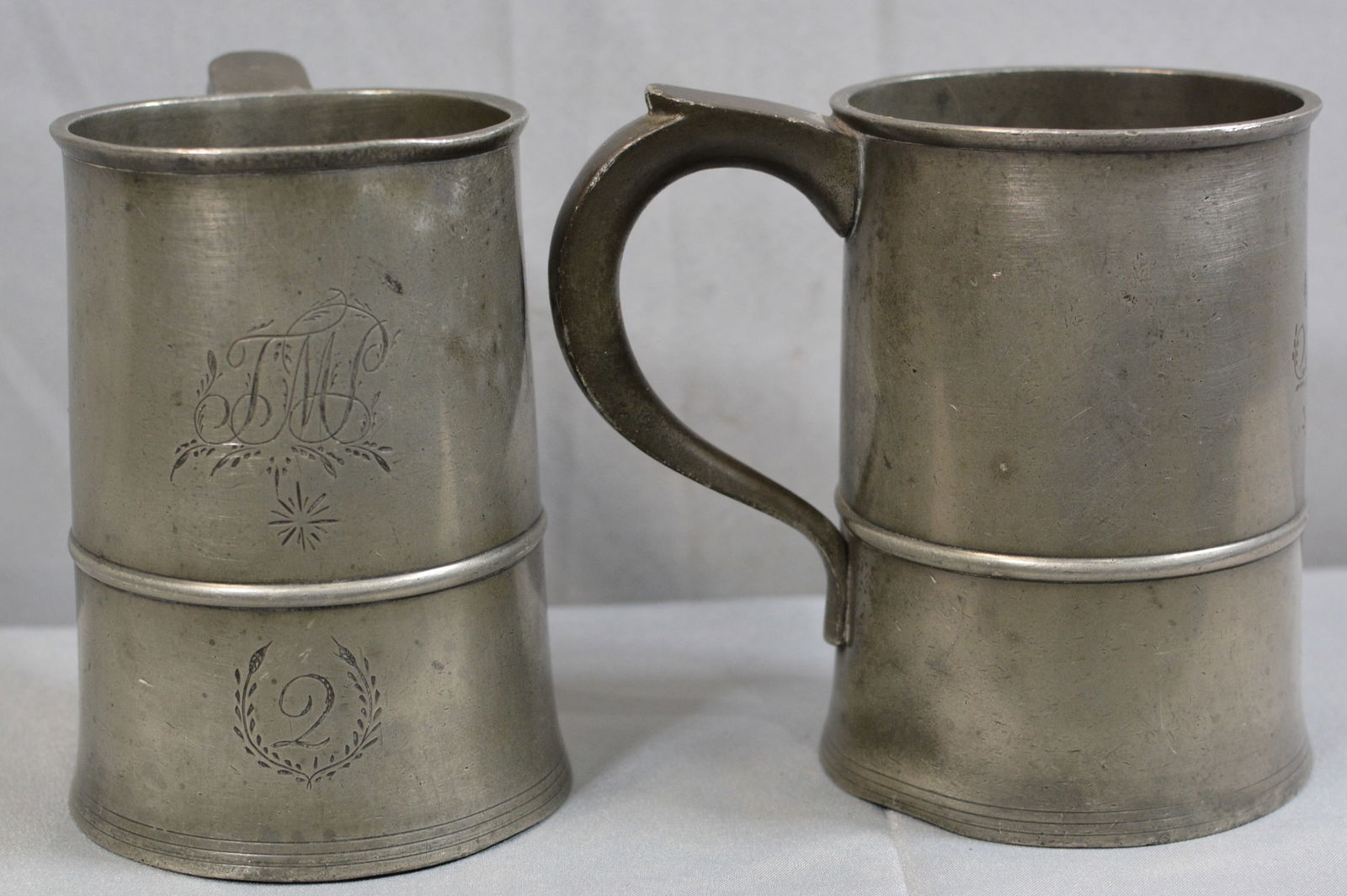 Two early pewter measuring mugs, English touchmark over NO. 4, monogramed with initials, leaf (1 of 8)