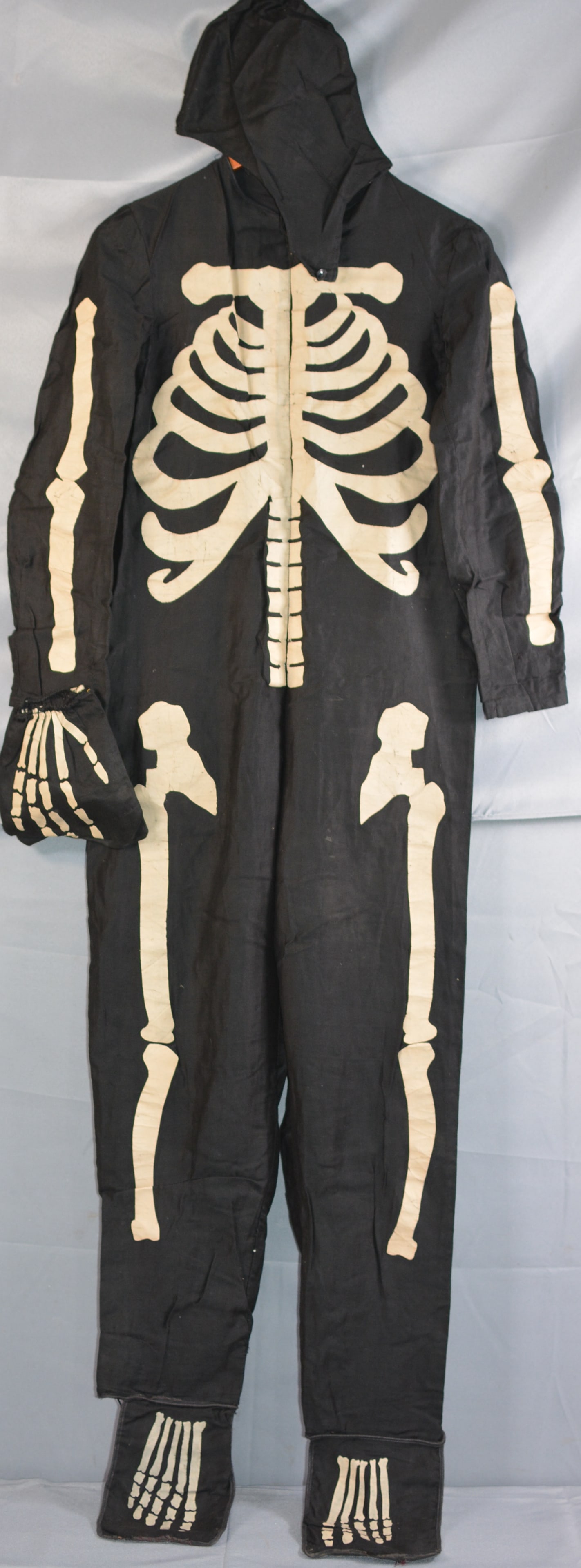 1940's full body skeleton costume, black with white applied skeleton figure/bones, button back,: 1940's full body skeleton costume, black with white applied skeleton figure/bones, button back, shoe, hand covers, and hood, made by Halco, size 14, cleaning receipt from Crown Laundry 1945, very good