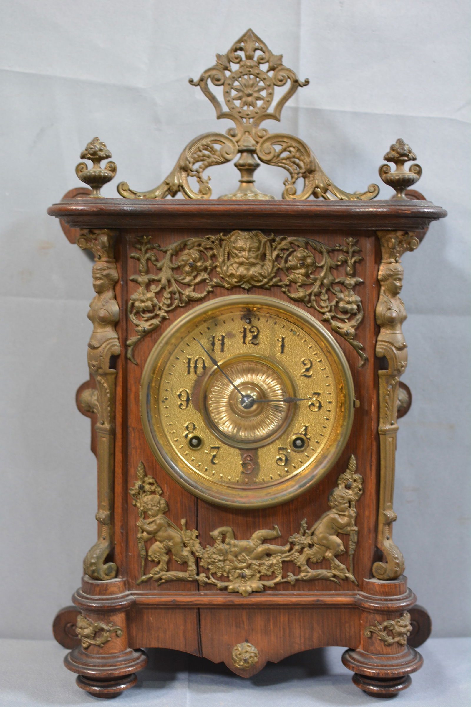 Ornate oak mantle clock, brass movement, 10"X14"4": Ornate oak mantle clock, brass movement, 10"X14"4"