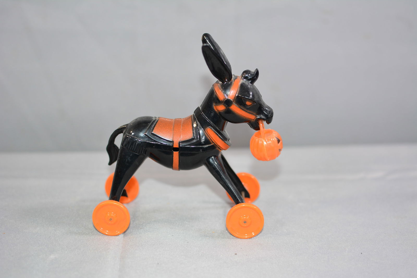 Vintage Halloween Rosbro Donkey on wheels, has candy container jack o lantern in mouth, black with: Vintage Halloween Rosbro Donkey on wheels, has candy container jack o lantern in mouth, black with orange accents. 6"x5"