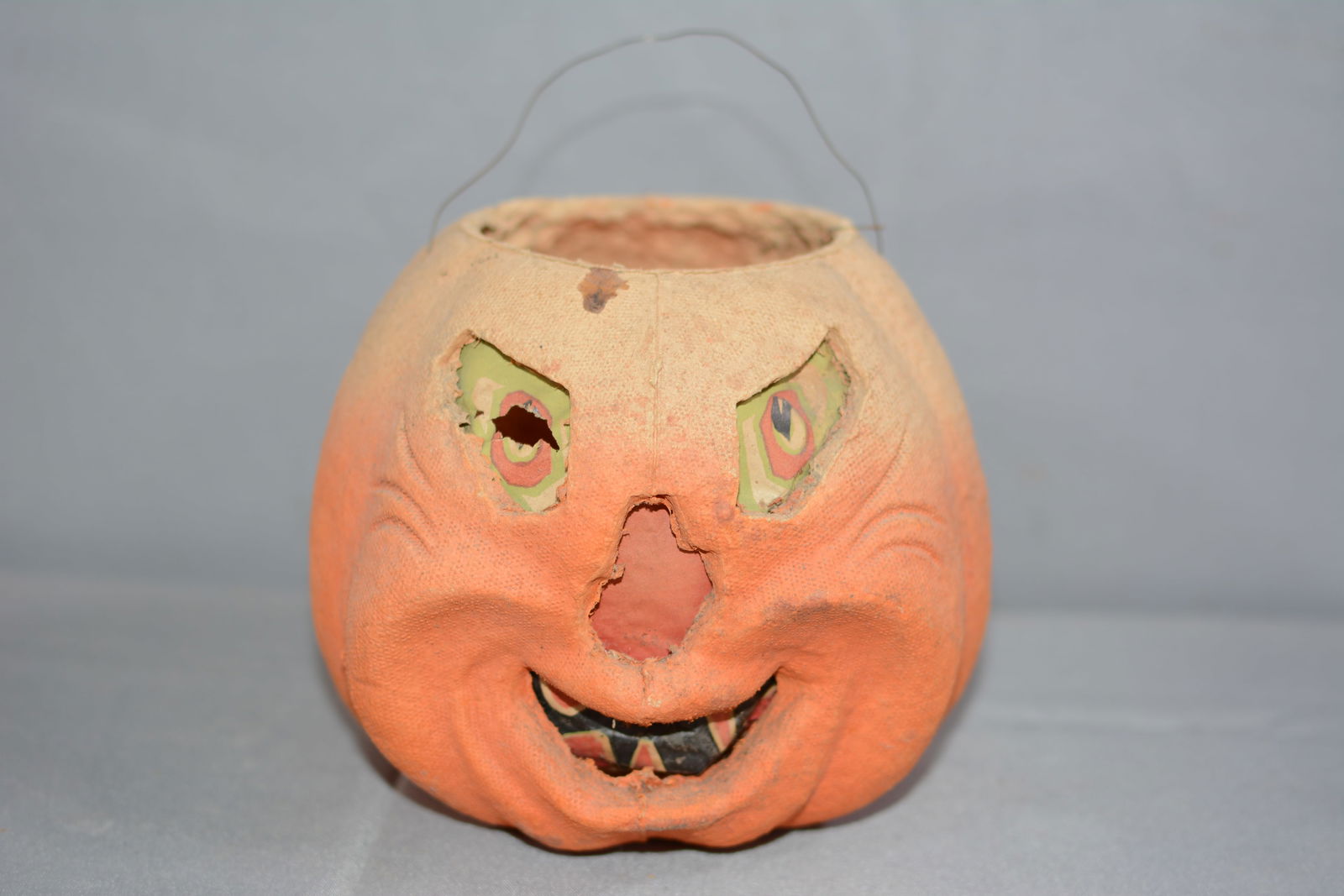 Vintage paper mache jack O lantern with paper face insert, wire bail handle, bottom is marked F.N. (1 of 7)