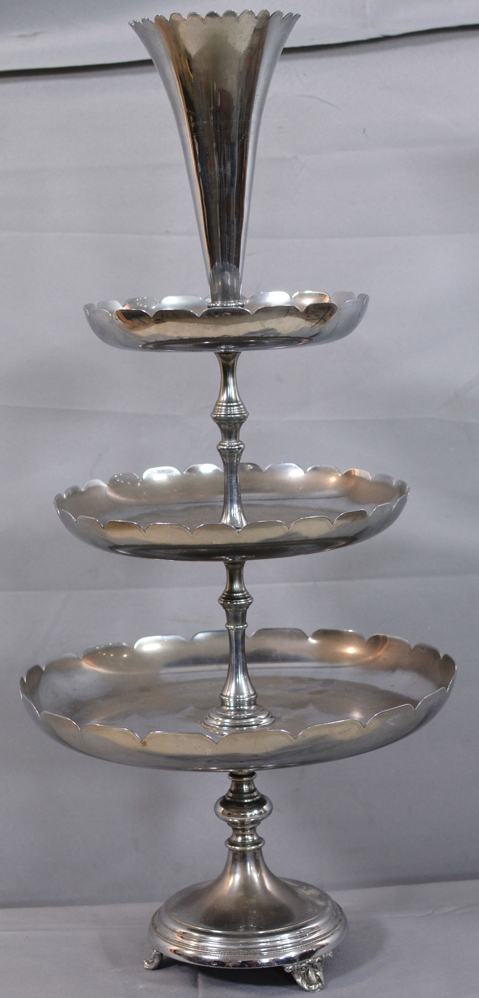 Three tiered dessert stand with scalloped trays and footed base below a trumpet vase with scalloped: Three tiered dessert stand with scalloped trays and footed base below a trumpet vase with scalloped top, 14"x 28"