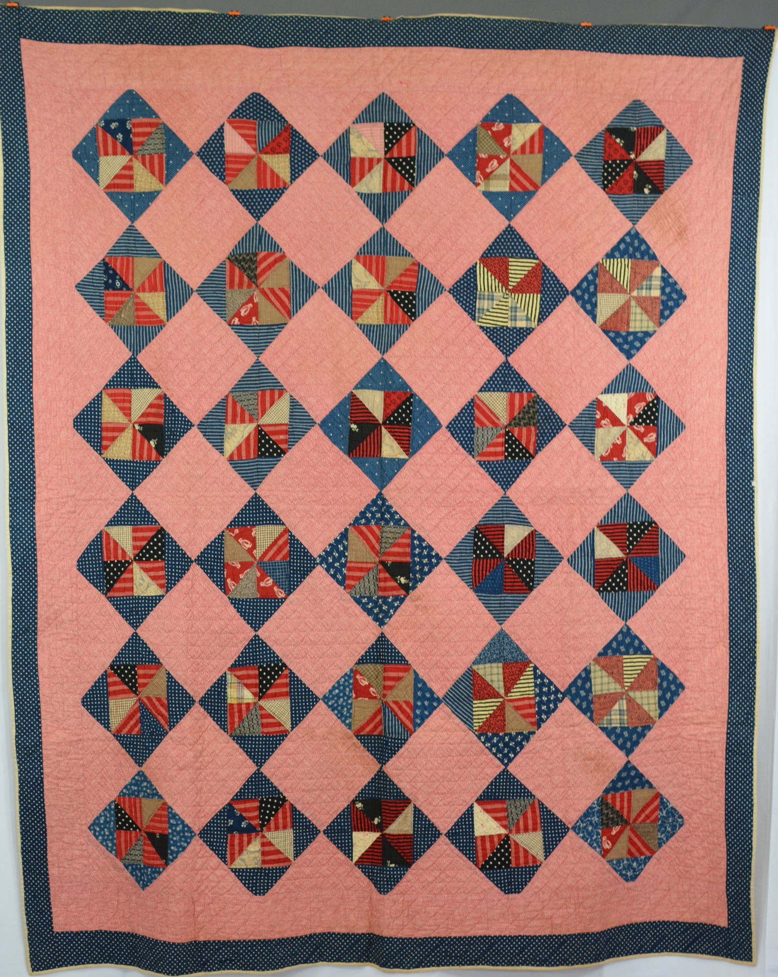 Pinwheel variation quilt w/ red background, blue & white polka dot border early 1900s. (1 of 3)