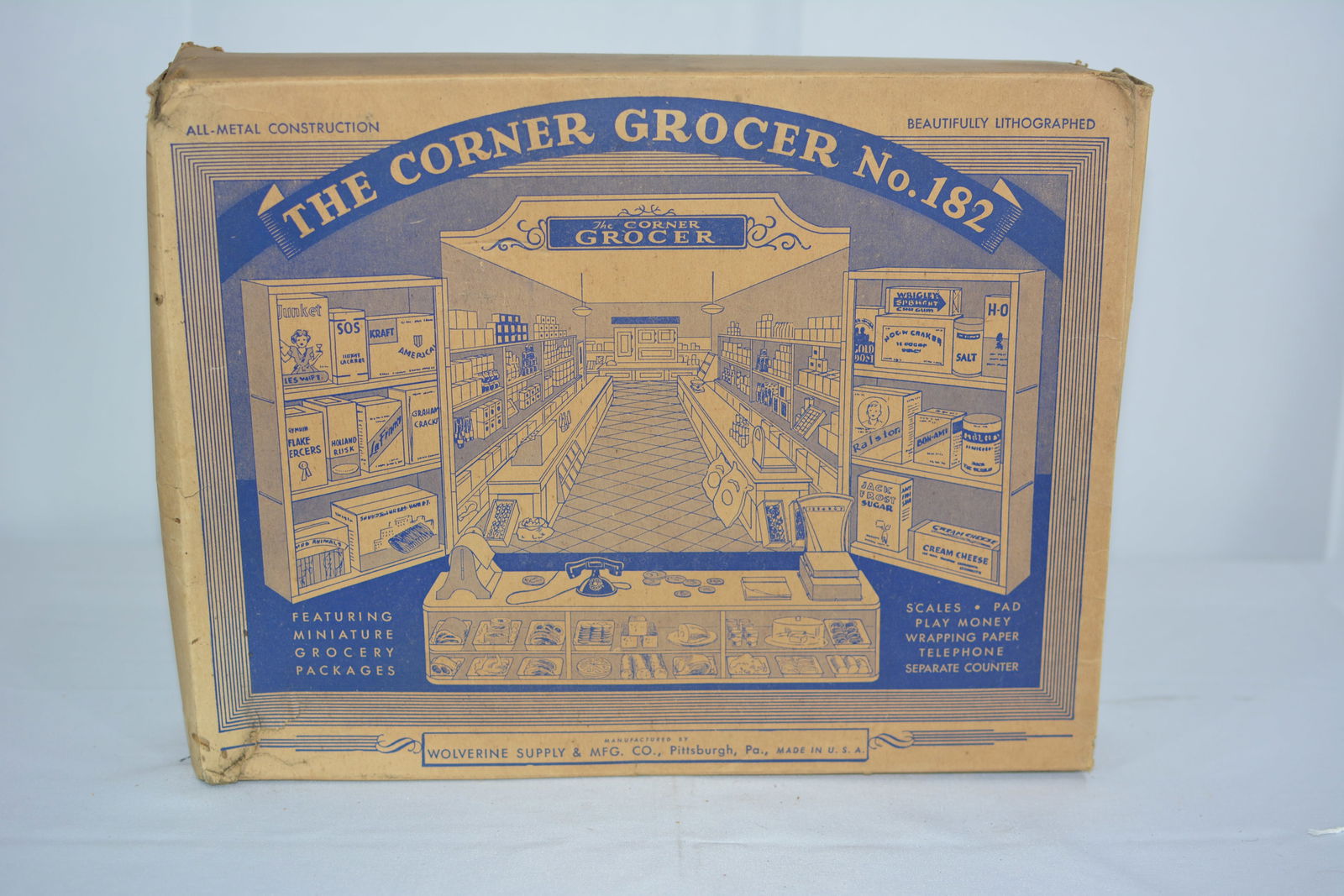 1930's Wolverine Toy Co. The Corner Grocery Store tin litho set in the original box with: 1930's Wolverine Toy Co. The Corner Grocery Store tin litho set in the original box with accessories, 14"x14"x2"