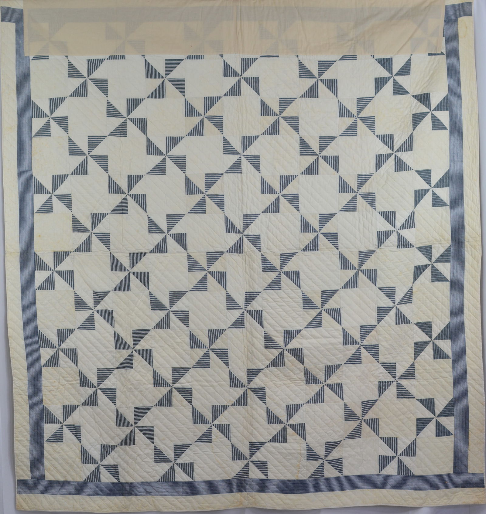 Late 1800s Pinwheel Touching Stars in blue & white. Some staining. Top border is wrapped in Muslim: Late 1800s Pinwheel Touching Stars in blue & white. Some staining. Top border is wrapped in Muslim for protection. 84"L x 76"W