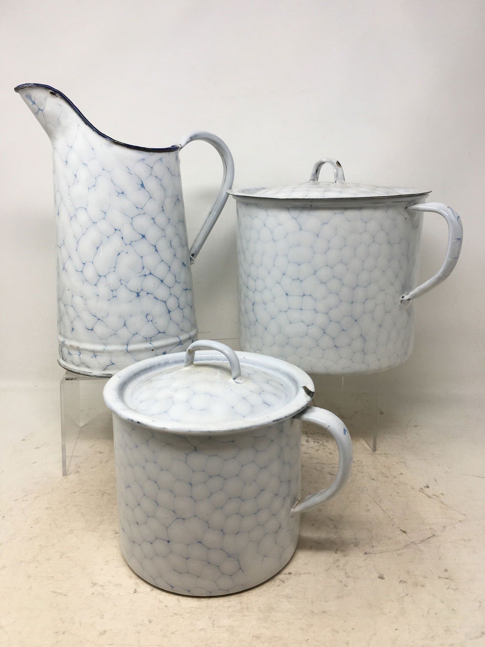Water pitcher & (2) sizes covered single-handled pots, in blue & white chicken wire pattern. Pots: Water pitcher & (2) sizes covered single-handled pots, in blue & white chicken wire pattern. Pots marked G&S, 18E & 14G. Pitcher 9.75" H