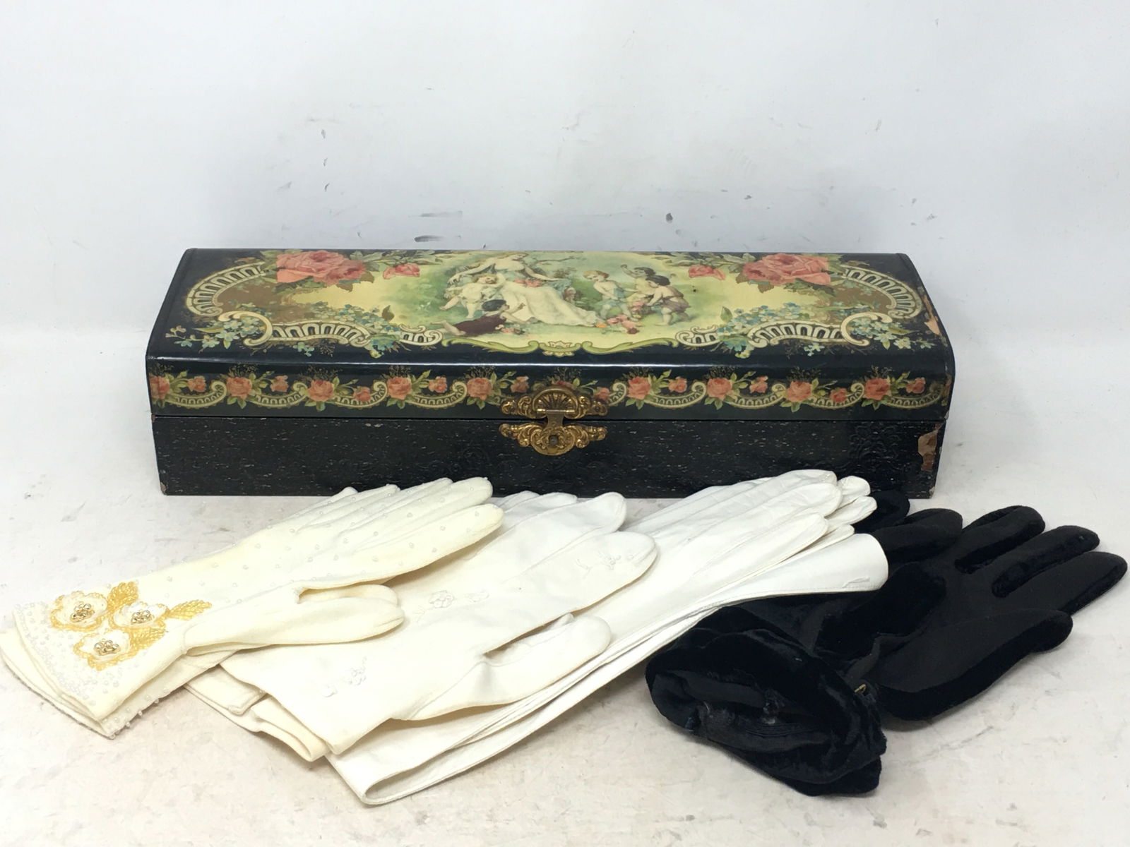 Victorian Decorated Glove Box, Lacquer Style Box with Gilt Clasp. Some loss of decor at end of box.: Victorian Decorated Glove Box, Lacquer Style Box with Gilt Clasp. Some loss of decor at end of box. Silk lined interior, with wear. (4) pairs vintage ladies' gloves, one beaded pair, one pair with flo