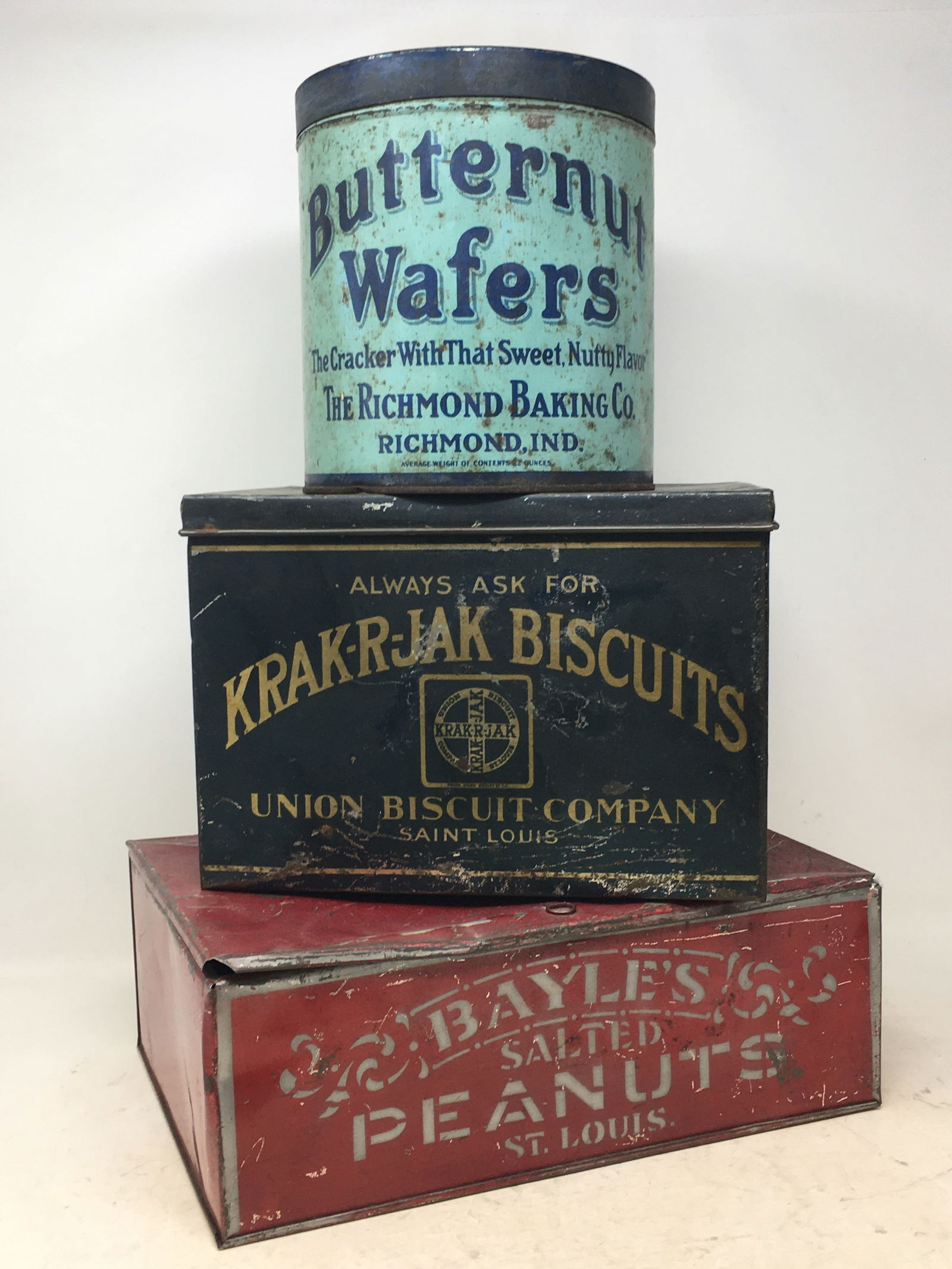 (3) Advertising Tins. 1) Butternut Wafers, Richmond Baking Co., Richmond Ind., 7"H; 2) Krak-r-jak: (3) Advertising Tins. 1) Butternut Wafers, Richmond Baking Co., Richmond Ind., 7"H; 2) Krak-r-jak Biscuits, Union Biscuit Company, St. Louis, 10.25"L x 8.25"W x 7"H; 3) Bayle's Salted Peanuts, St. Lou