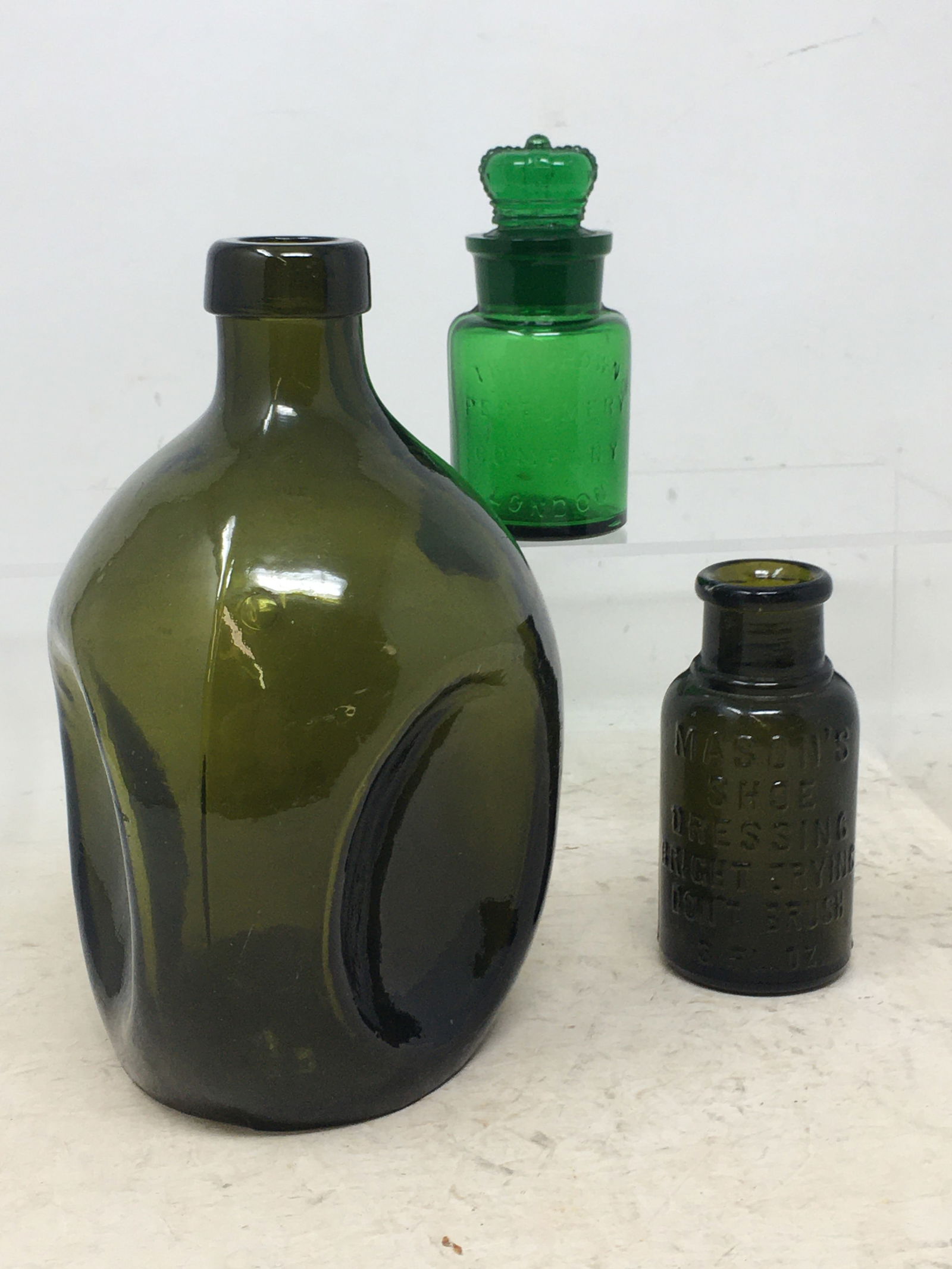 1) 3-sided pinch grip whiskey bottle, olive green, 7.25"H. 2) Perfume bottle with crown stopper, (1 of 8)