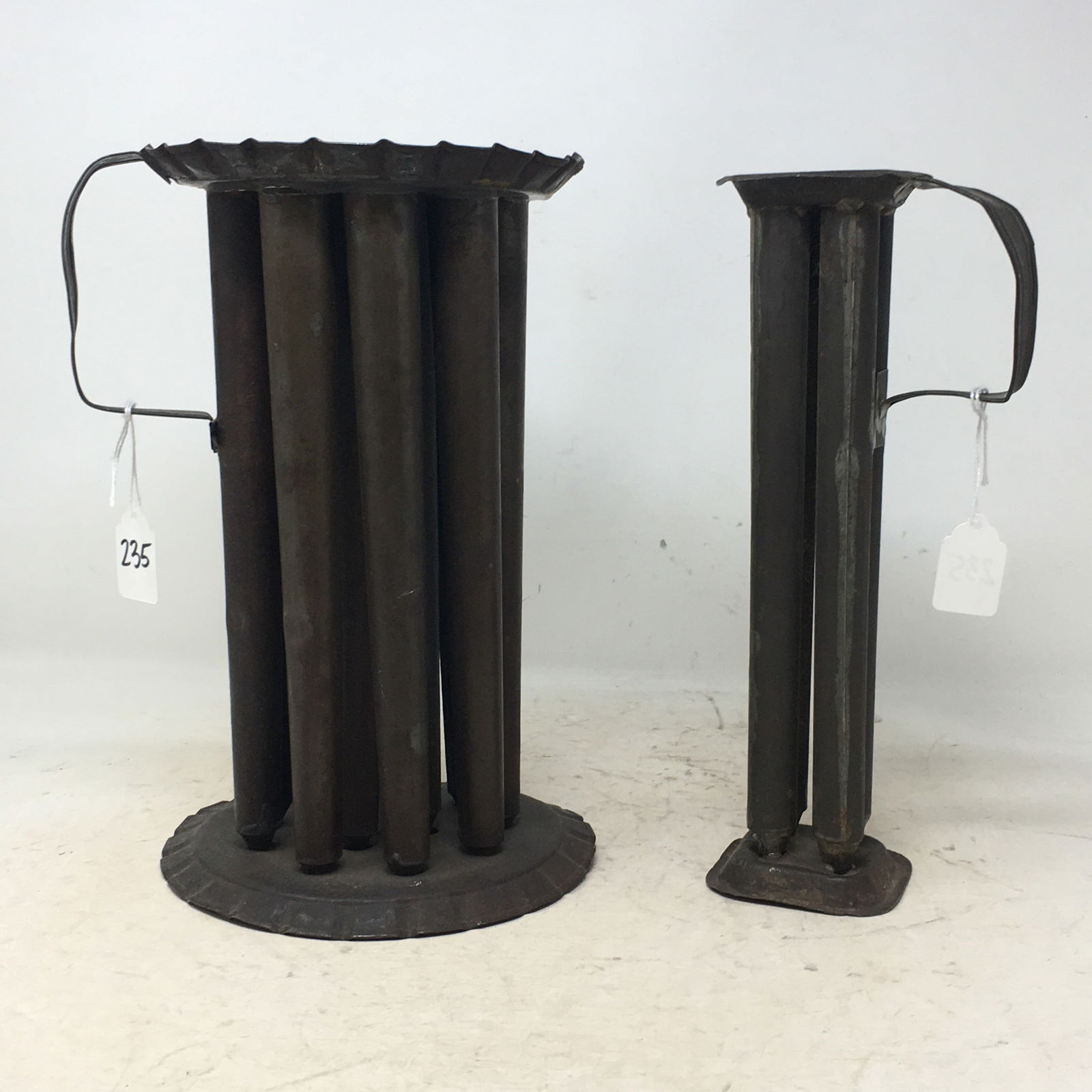 (2) Tin Candle Molds. 1) Round 12-candle mold with strap handle & fluted top & bottom, 10.75"H. 2) (1 of 3)