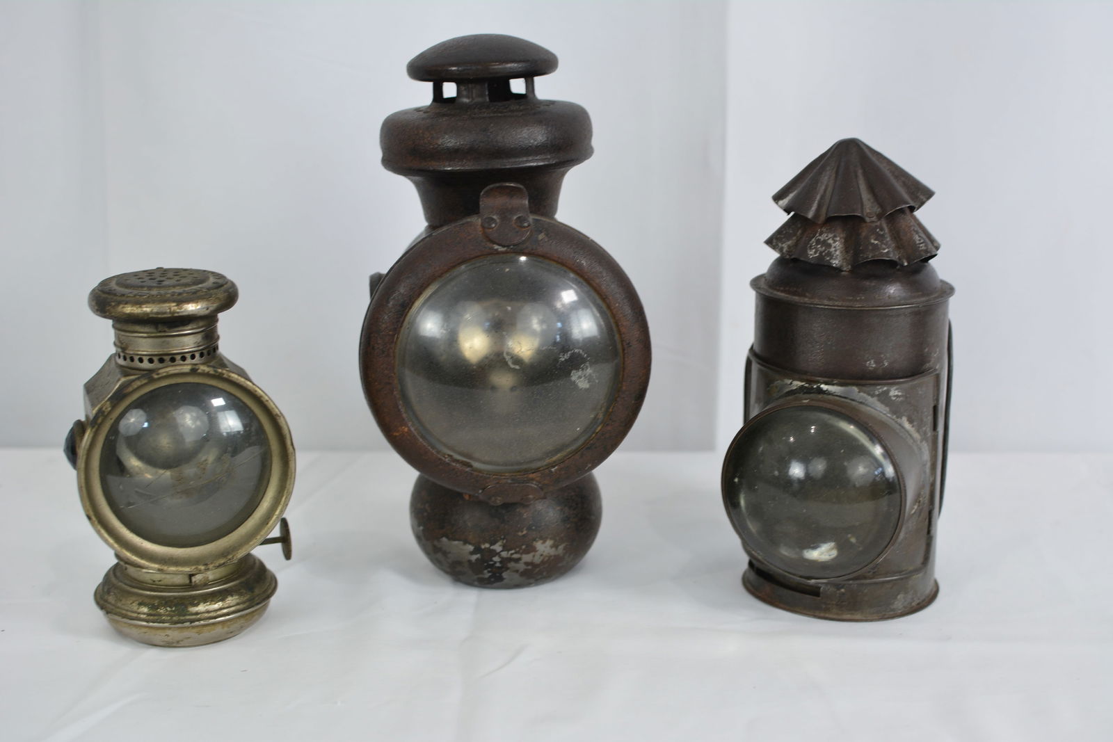 Three kerosene lanterns: one is Columbia Bicycle lamp made by Hine-Watt Mfg. Co. (cracked lens) , (1 of 8)