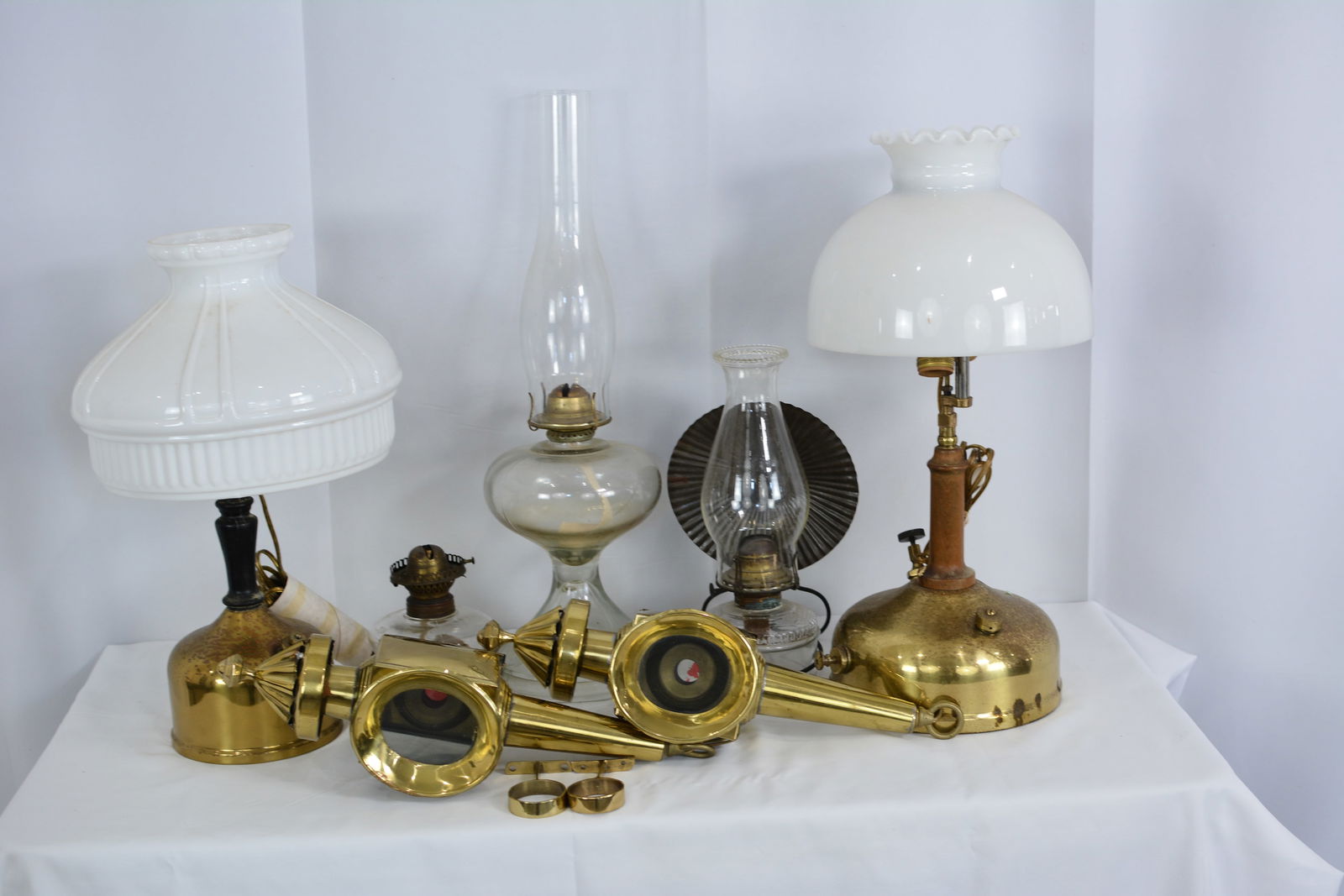 Seven pieces of early lighting includes: two Coleman style lamps w/ milk glass shades, two brass (1 of 4)