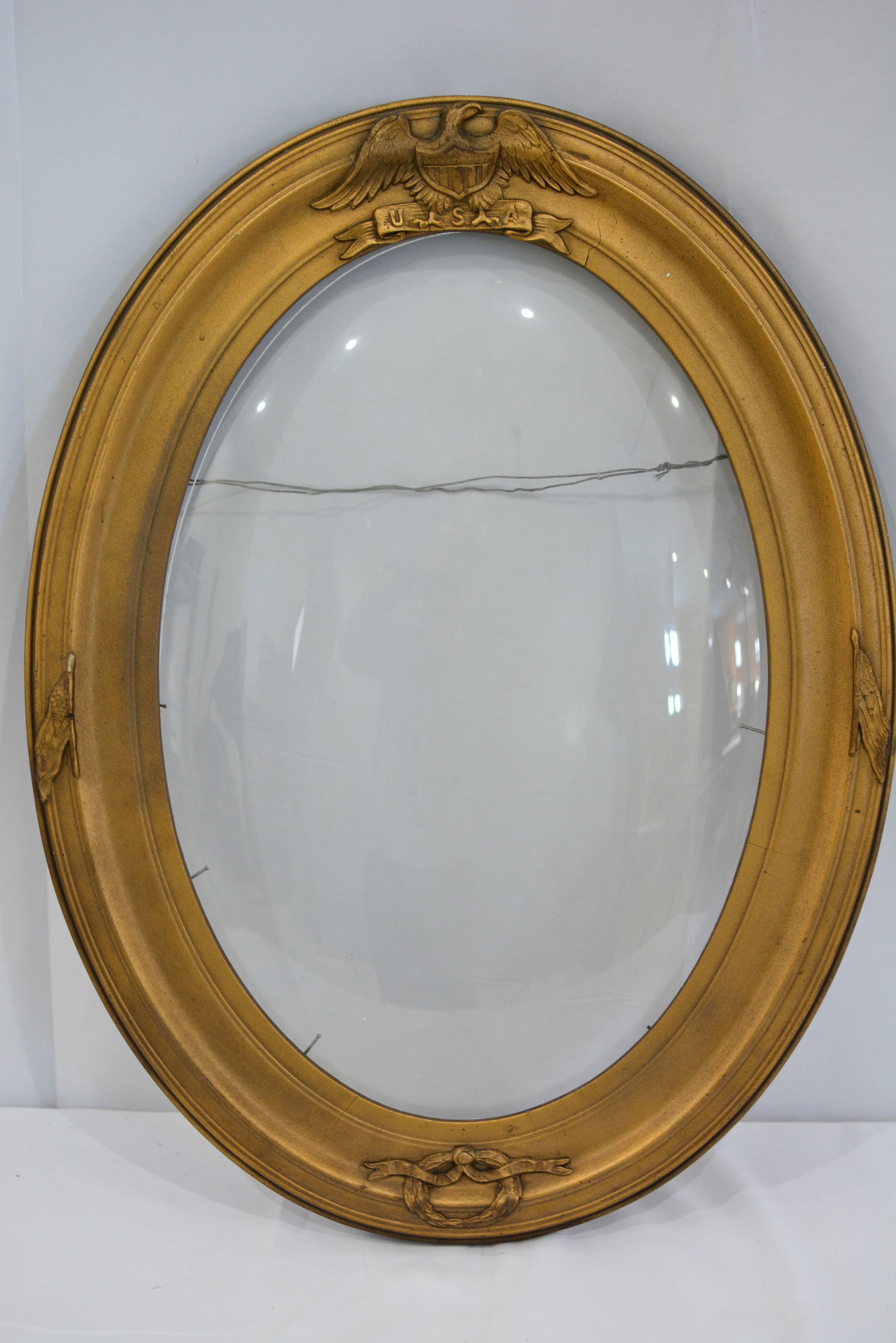 WWI oval gilded frame w/beveled glass has eagle w/shield, flags & memorial wreath. 14" x 20": WWI oval gilded frame w/beveled glass has eagle w/shield, flags & memorial wreath. 14" x 20"