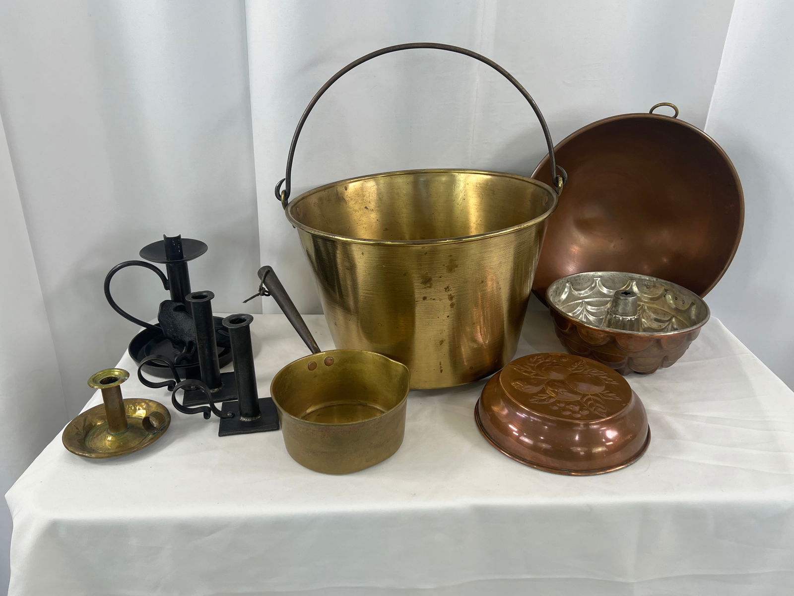 Brass Pail, Pots, and Candlesticks: Brass Pail, Pots, and Candlesticks, bail handled bucket and sauce pan in brass, food molds and copper bowl, candlesticks and a crow bottle opener.