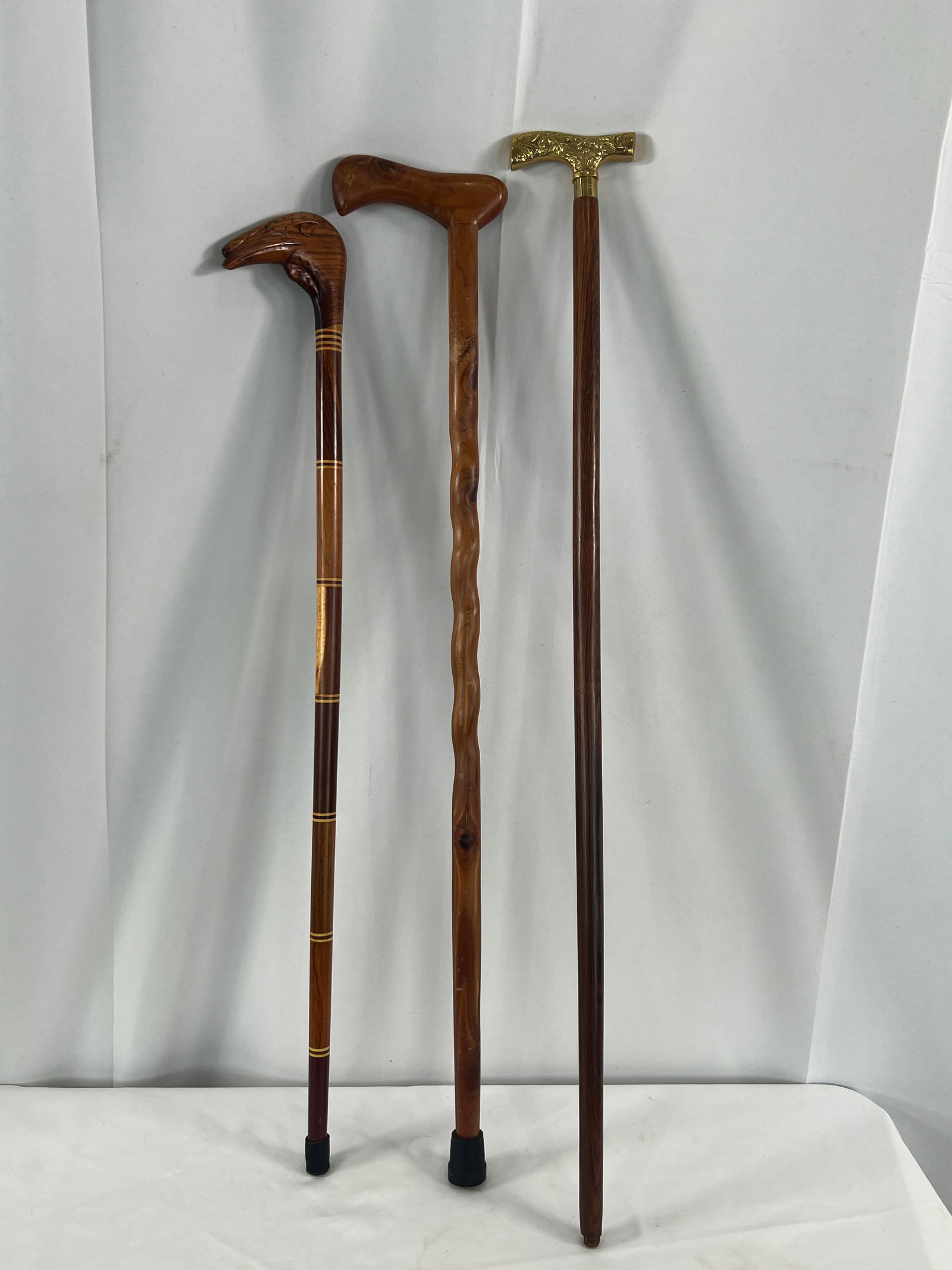 3 Walking Canes: 3 Walking Canes, carved turkey head, rope twist, and a brass handled.