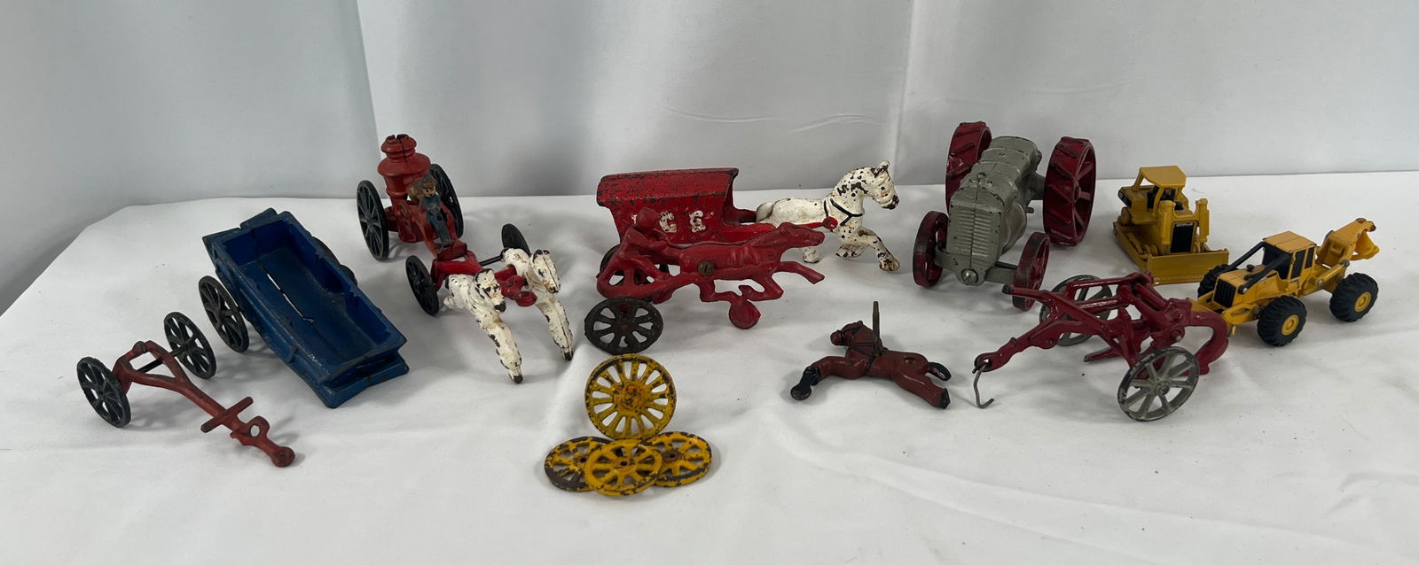 Cast Iron Toys and Parts: Cast Iron Toys and Parts, CI Tractor, sulky, horse drawn fire engine, plow, and parts.