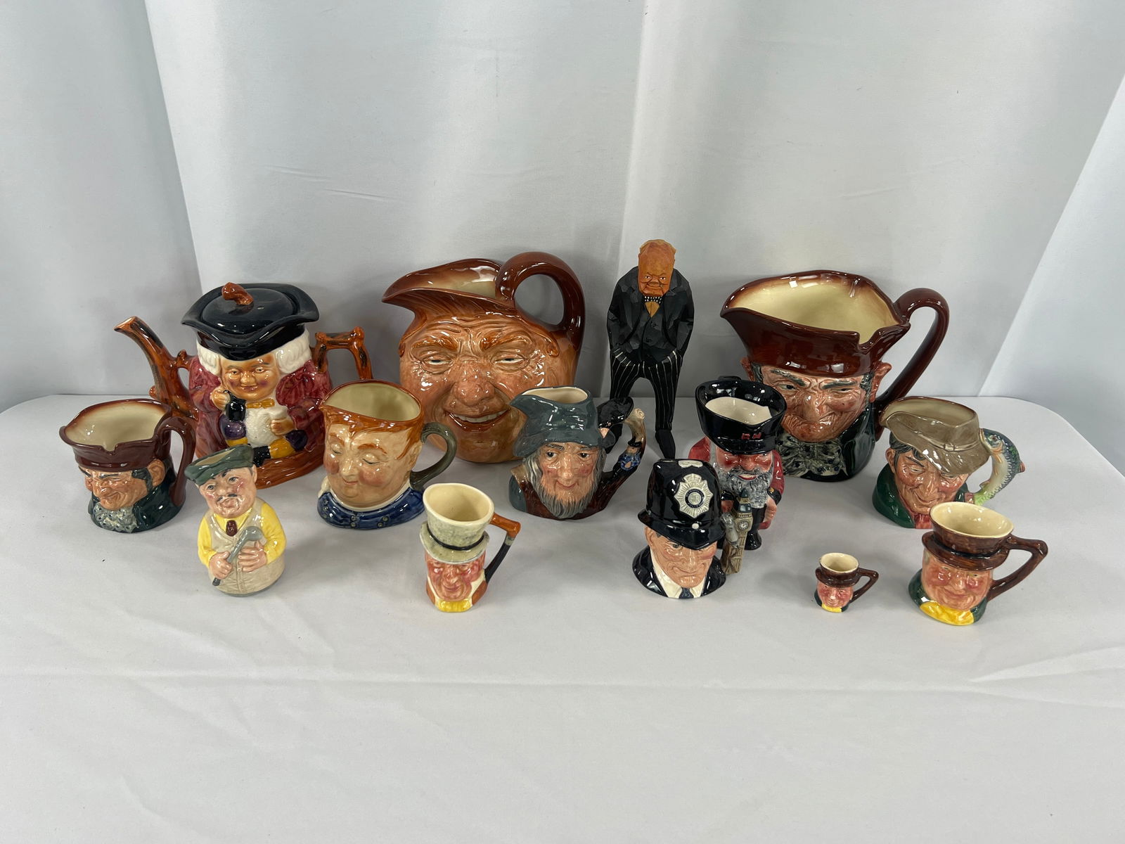 Group of Royal Doulton Toby's: Group of 13 Royal Doulton Toby's and Shorter Tea Pot, old marks and new marks,