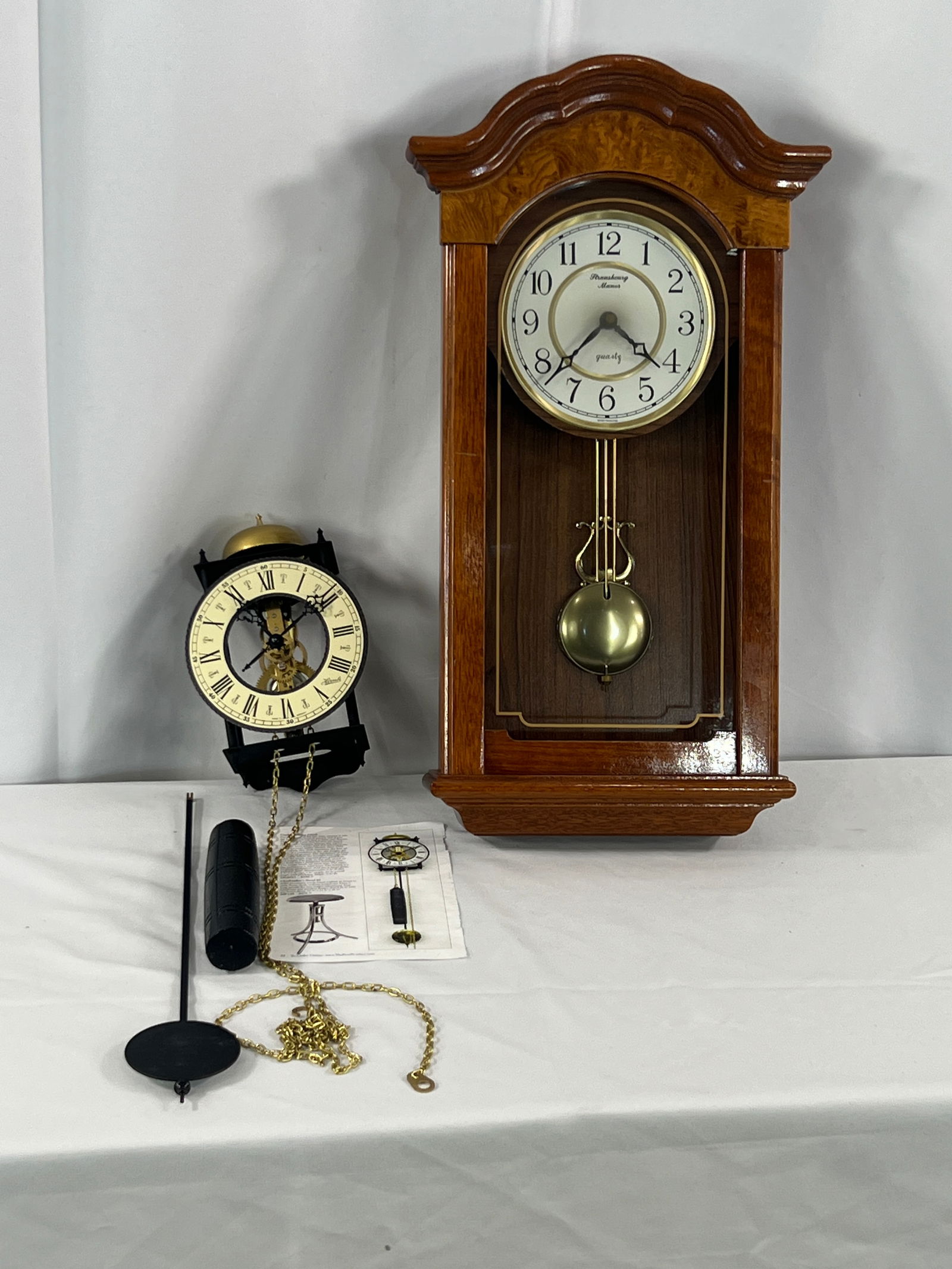 2 Wall Clocks: 2 Wall Clocks, Castle Skeleton Clock, wood case wall clock.