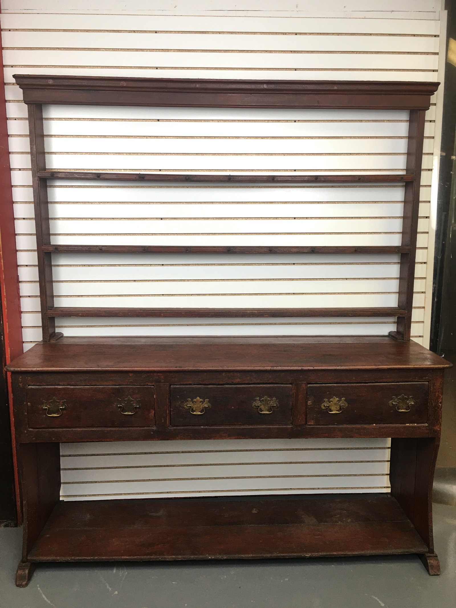 Pewter Cupboard, Old Red Paint: Pewter Cupboard in Old Red Paint. Two pieces: open upper section with plate rails and hooks; base has 3 drawers and lower open shelf. 71.5"W x 23.5"W x 83"H