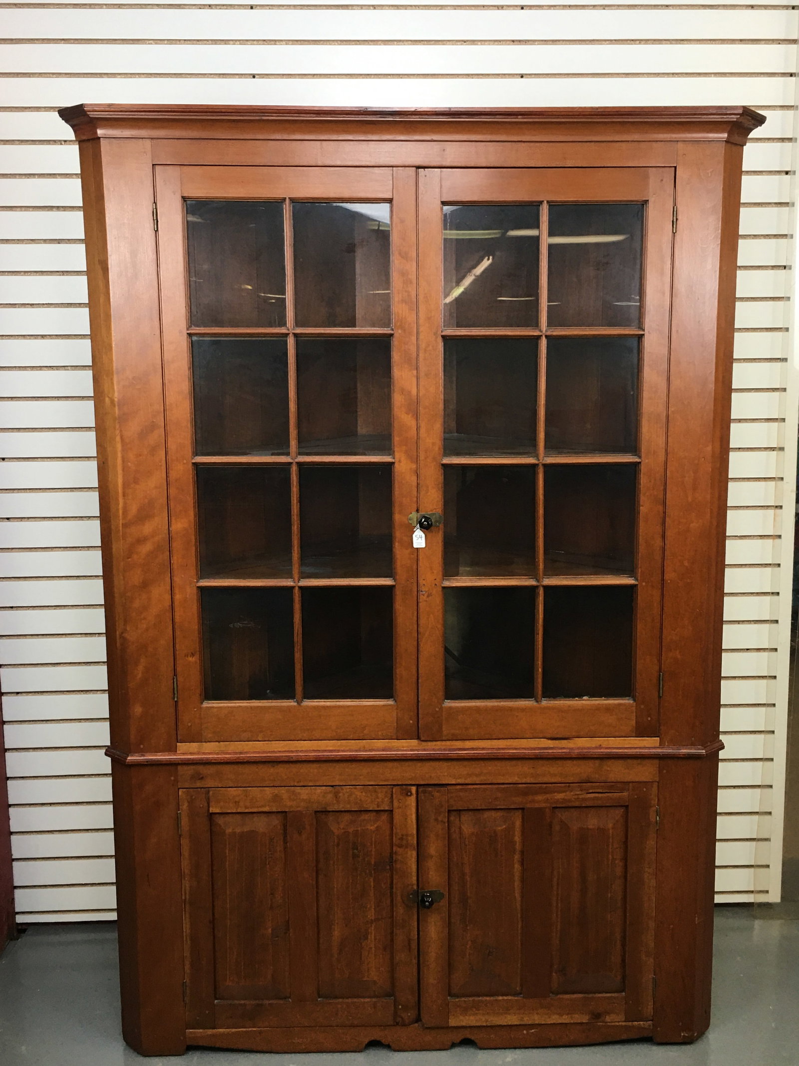 16-Pane Cherry Corner Cupboard: 16-Pane Cherry Corner Cupboard. Two 8-pane upper doors over two lower doors. 4 shelves up top with plate grooves. One lower shelf. Small missing piece to crown trim. 53"W x 22.5"D x 78.5"H