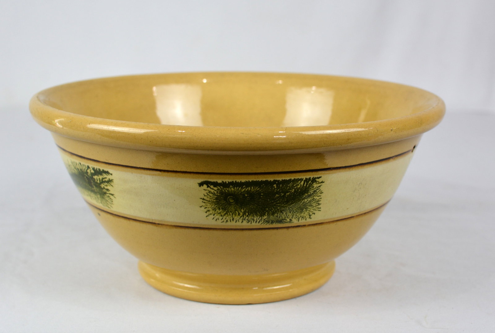 Large Yellowware Mocha Decorated Bowl: Yellowware large bowl with mocha decoration green seaweed displayed on a cream-colored slip band bordered by two bands. Size: 11 in. D x 6.6 in. T