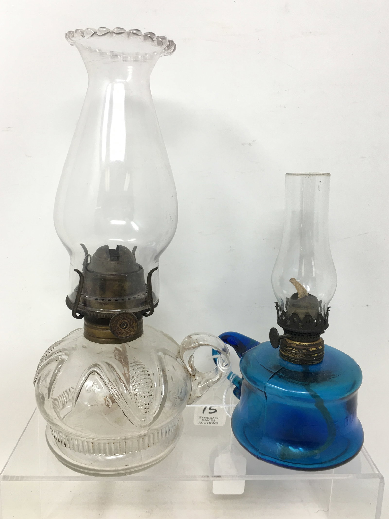 (2) Miniature Finger Oil Lamps: (2) Miniature Finger Oil Lamps. 1) Cobalt embossed "Little Butter Cup". 2) Embossed ears of corn, bottom marked Pat'd Feb. 11. 1873. 9.25" w/ shade.