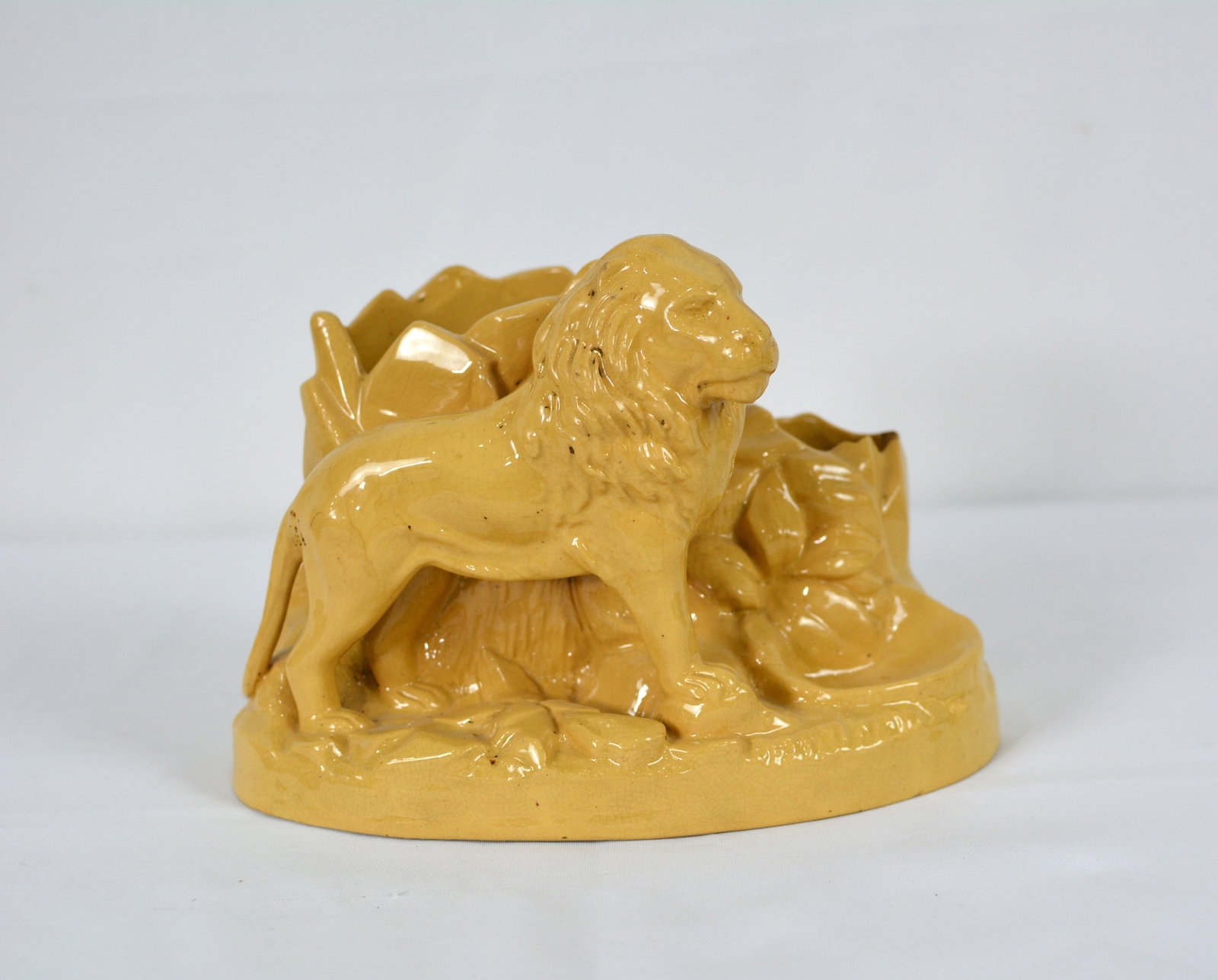 Yellowware Glazed Pottery Lion Figural Pipe and Match Stand: Yellowware Glazed Pottery Lion Figural Pipe and Match Stand, age-related wear, glaze imperfections, and minor surface marks consistent with use and age. Approximately 8 in. W x 5 in. D x 6 in. H.