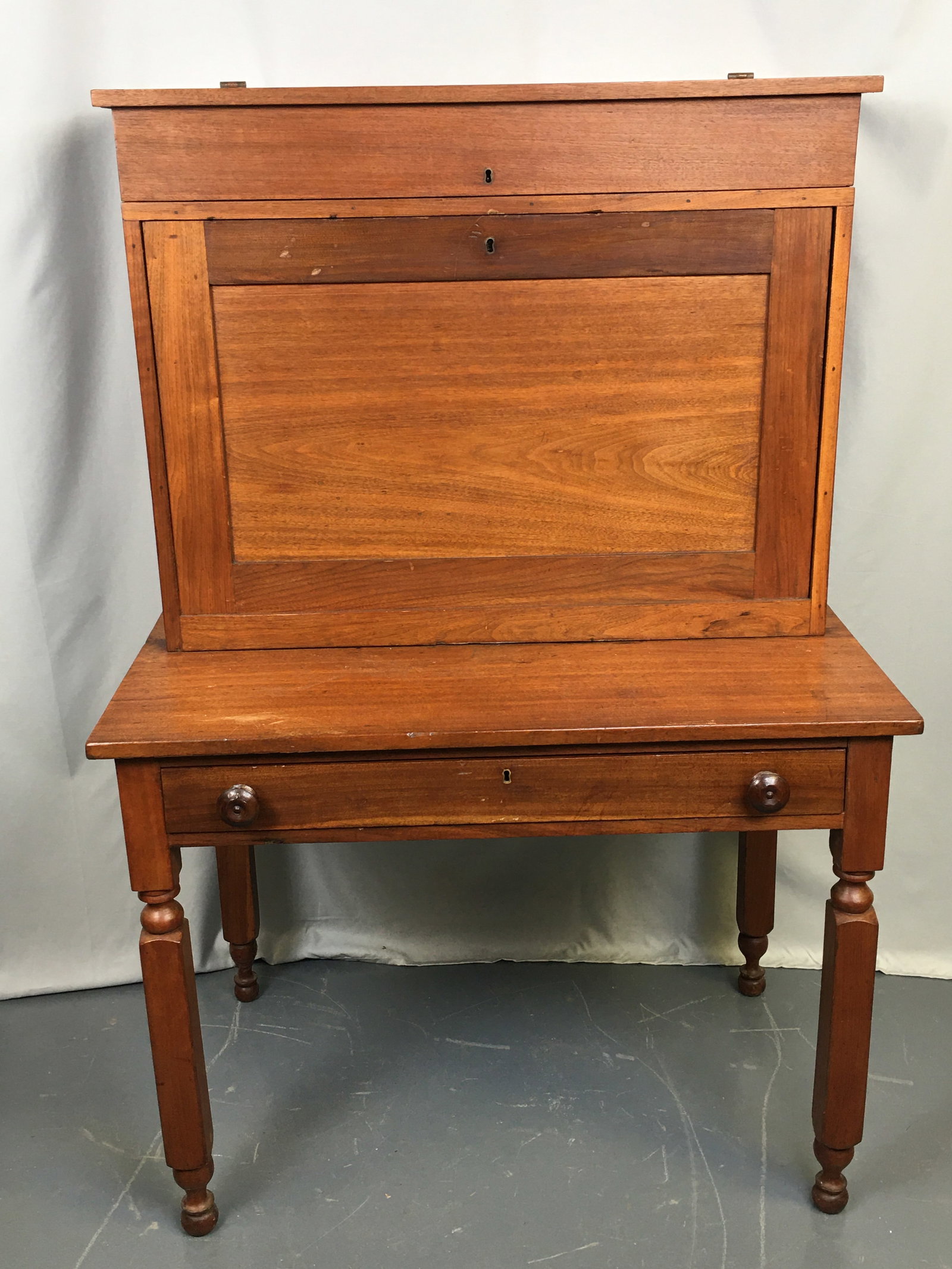 19th Century Plantation Desk: 19th Century Plantation Desk. Upper flip top with 8 cubbies; drop front with 12 cubbies, a drawer, one large section and three paper slots. With key. Lower section with single drawer having wood