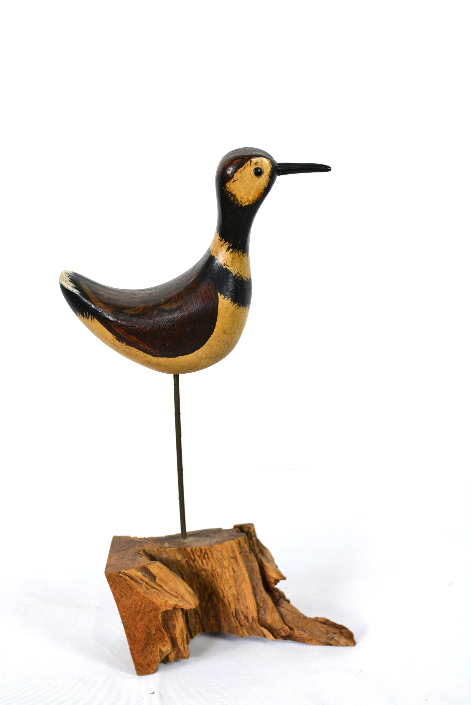 Folk Art Shorebird Carving on Driftwood Base: Folk Art Shorebird Carving by Jim Slack of Pekin, IL, on Driftwood Base, hand-painted black and mustard-yellow coloration with simple, whimsical styling. 4 in. W × 3 in. D × 13 in. H.