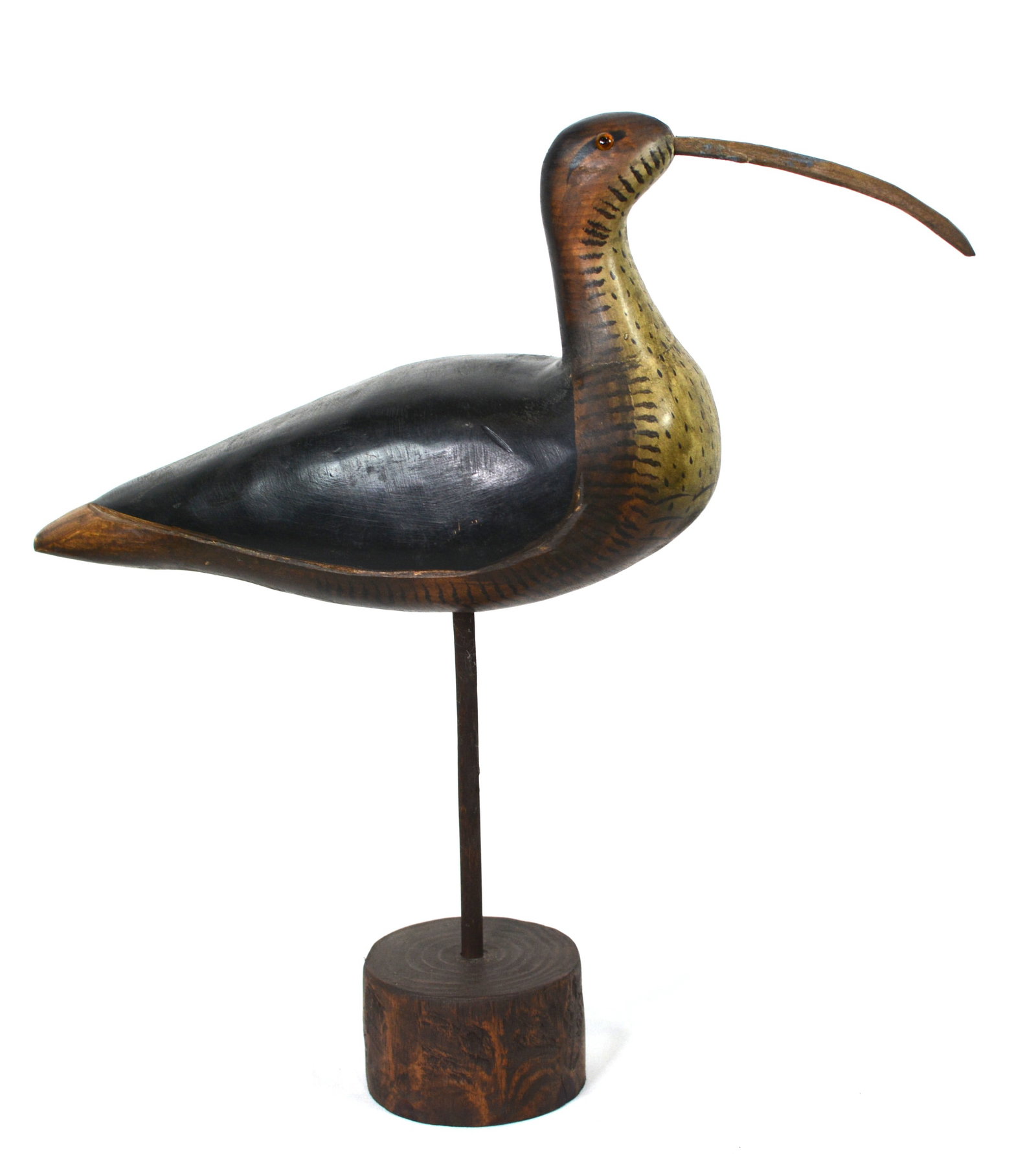 Hand-Carved Curlew Shorebird: Folk Art hand-carved wooden shorebird, form of a costal curlew, mounted on a turned wood base. The carving features a gracefully curved bill, detailed painted feather accents. 14 in. L × 4 in. W × 1