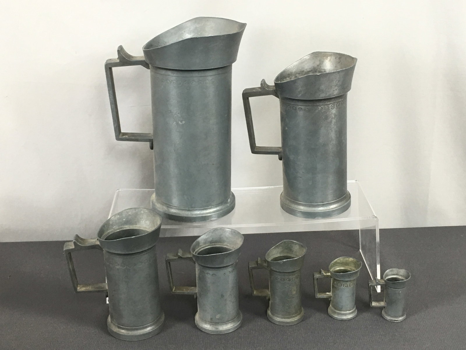 Pewter Measures, Set of 7: Pewter Measures, Set of 7. Graduated sizes, marked on handles. Liter, 1/2 liter, 2 deciliter, deciliter, 1/2 deciliter, 2 centiliter, centiliter. Tallest 8 3/8"H, smallest 2".