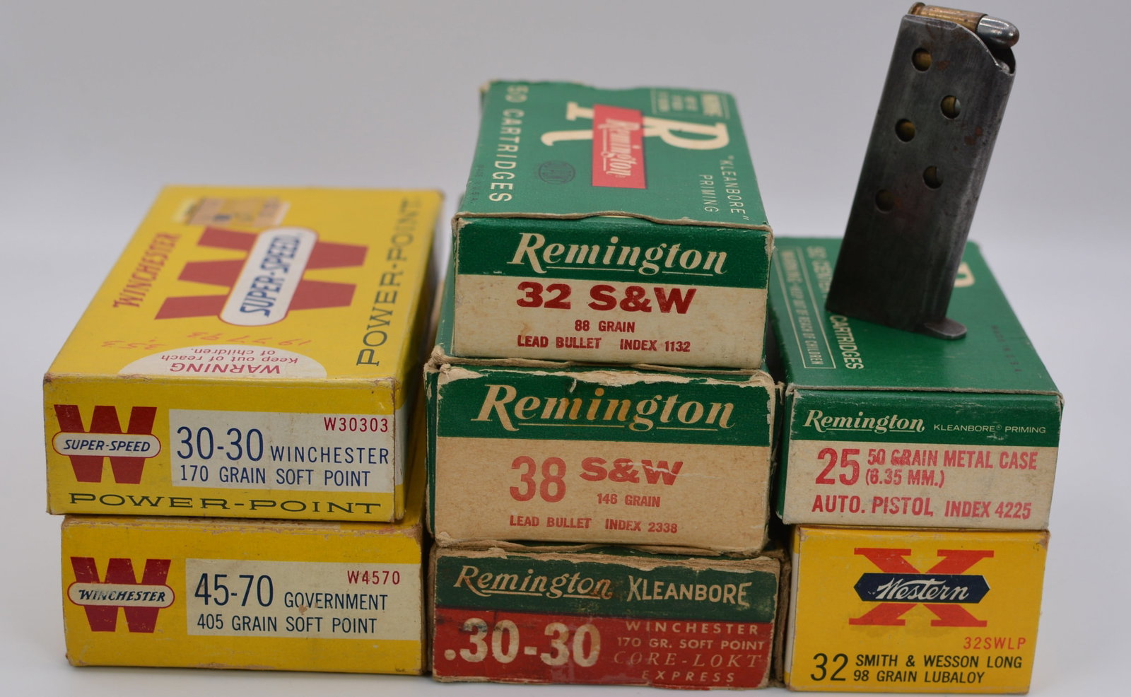 Vintage Ammunition Lot with Winchester, Remington & Western Cartridge Boxes and Pistol Magazine: Collection of vintage sporting ammunition consisting of multiple original cartridge boxes , including Winchester, Remington, and Western. Visible calibers include .30-30 Winchester, .45-70 Government,